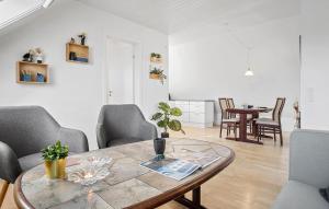 a living room with a table and chairs at Beautiful Apartment In Dalmose With Wi-fi 