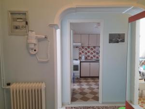 una puerta abierta a una cocina con suelo de tablero de ajedrez en Friendly Philoxenia en Xanthi