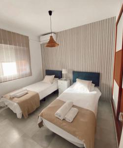 A bed or beds in a room at Apartamento Melina Arlu - Barrio La Victoria