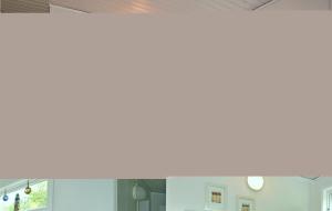 a large window in a room with white walls at One-Bedroom Holiday Home In Hunnebostrand in Hunnebostrand +4 photos