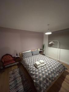 a bedroom with a bed with two towels on it at Woodhouse Apartment in Headingley
