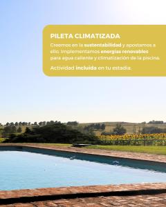 a picture of a pool of water next to a vineyard at Estancia Ave María in Tandil