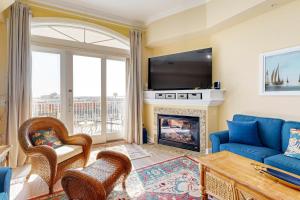 a living room with a blue couch and a fireplace at South Beach 704 in Ocean City