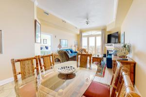 a living room with a glass table and chairs at South Beach 704 in Ocean City