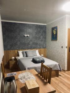 a bedroom with a bed and a table with glasses on it at 4 PORY ROKU POKOJE GOŚCINNE in Kamesznica