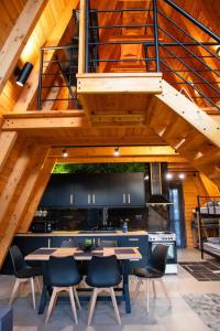 a kitchen with tables and chairs under a staircase at TO SPITI MOU in Drama