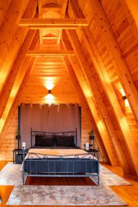 a bedroom in a log cabin with a bed at TO SPITI MOU in Drama
