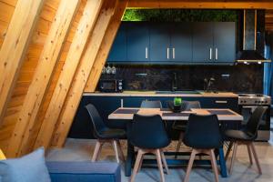 a kitchen with a table and chairs in a room at KOVU chalet in Drama