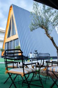 a picnic table and chairs in front of a building at TO SPITI MOU in Drama