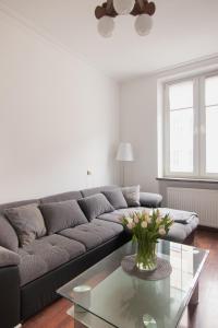 a living room with a couch and a glass table at Just Stay Apartments One Bedroom Old Town Apartment in Gdańsk