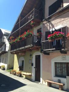 a building with flower boxes and balconies on it at IL Dahù in Pragelato
