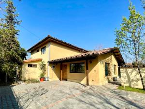 a house with a driveway in front of it at Olea's Home Las Condes in Santiago