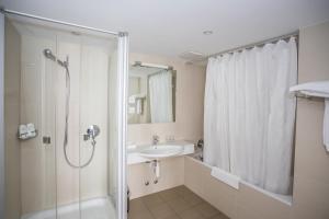 a bathroom with a shower and a sink at Hotel Höri Inn in Höri