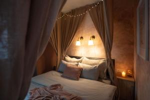a bedroom with a canopy bed with pillows at Pretty Jolie Romantic Getaway in Bled +23 photos