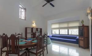 a dining room with a table and a blue couch at 519@jamtree in Colombo +22 photos