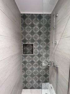 a bathroom with a shower with a glass door at Casa al Centro, Kos old town in Kos