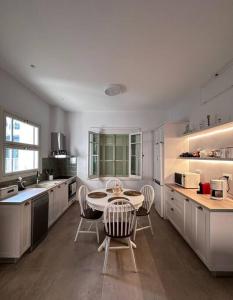 a large kitchen with a table and chairs in it at Casa al Centro, Kos old town in Kos +37 photos