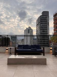 a couch sitting on top of a balcony at Studio ANHANGABAÚ in São Paulo