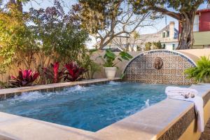 a swimming pool with a water feature in a backyard at Bayfront Marin House in Saint Augustine