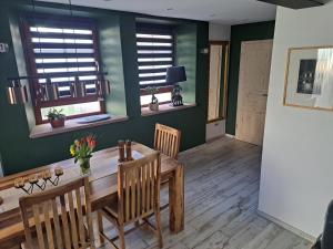 a dining room with a wooden table and chairs at Gästehaus Merlin in Bad Bergzabern