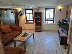 a living room with a couch and a coffee table at Gästehaus Merlin in Bad Bergzabern