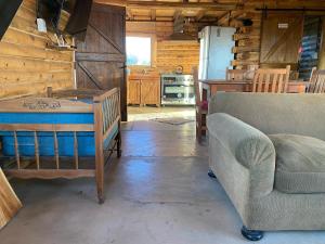 a living room with a couch and a table at Cabaña Vista del Plata in Las Compuertas