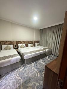 Postel nebo postele na pokoji v ubytování فندق اسكنت الذهبية - Askant Golden Hotel