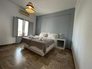 a bedroom with a bed and a large window at Pension George in Karterados