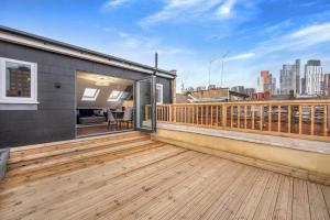 a balcony with a wooden deck with a view of the city at Luxury Apartments Victoria, London Eye, Big Ben in London