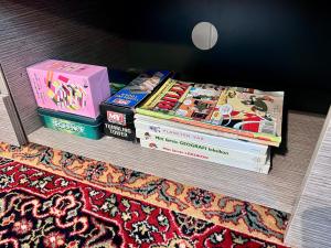 a stack of books sitting on top of a shelf at Fjord-View Apartment in Nese