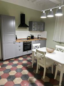 a kitchen with a white table and a table and chairs at Antica dimora in Borgo a Buggiano