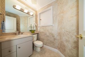 a bathroom with a toilet and a sink and a mirror at 38-Villa in Vancouver
