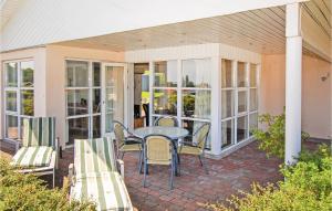 a patio with a table and chairs on a porch at Holiday Home Hvedemarken Sjølund Xii in Hejls