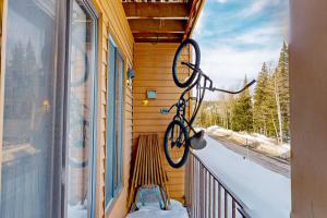 a bike hanging on the side of a balcony at Timberbrook #110B in Brian Head