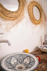 a bathroom sink with a plate on a counter at Soul Surf House in Agadir