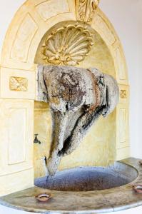 a statue of a dolphin in a fountain at Residence Mareluna - Amalfi Coast in Vietri sul Mare