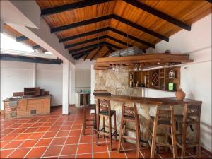 a kitchen with a wooden table and some chairs at Casa en San Cristóbal, urb los naranjos in San Cristóbal