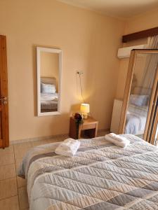A bed or beds in a room at Alexandra's Cozy Sea View Apartment