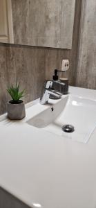 a white bathroom sink with a hair dryer on it at Lofoten Rorbu - Odin bua in Stamsund