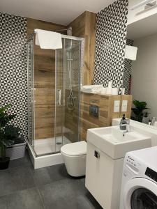 a bathroom with a shower and a toilet and a sink at City Sense - Brand New Apartment Close to the City Center and Main Station in Wrocław