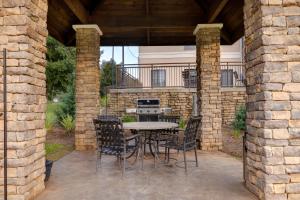 a patio with a table and chairs and a stove at Staybridge Suites Tallahassee I-10 East by IHG in Tallahassee +84 photos