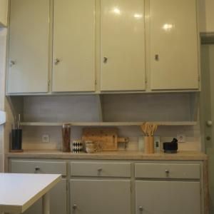 a kitchen with white cabinets and a counter top at Alvalade SkyView CoLiving in Lisbon