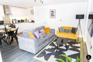 a living room with a couch and a table at Comfy & spacious Apt, 2 balconies, near the 02 arena, Greenwich in London