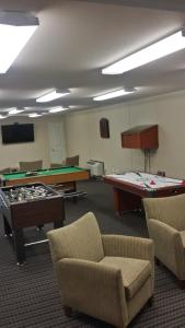 a room with two tables and a pool table at Instalodge Hotel and Suites Karnes City in Karnes City