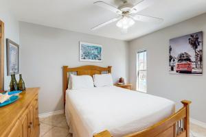 a bedroom with a bed and a ceiling fan at White Granite in South Padre Island