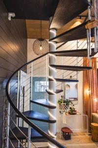 a spiral staircase in a house with a blue seat at The Sol Cottage+ Hiking+Creek Access+Views in Sedona