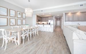 a kitchen and living room with a table and chairs at Phoenix Orange Beach II 2003 in Orange Beach +41 photos