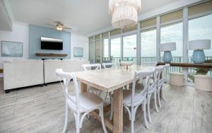 a dining room with a table and chairs at Phoenix Orange Beach II 2003 in Orange Beach