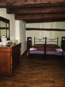 a bedroom with a bed and a wooden ceiling at IL Dahù in Pragelato