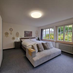 a large bedroom with a large bed and a couch at peaceful tiny house near forest in Rorschacherberg